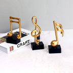 Escultura Decorativa de Nota Musical em Resina Dourada